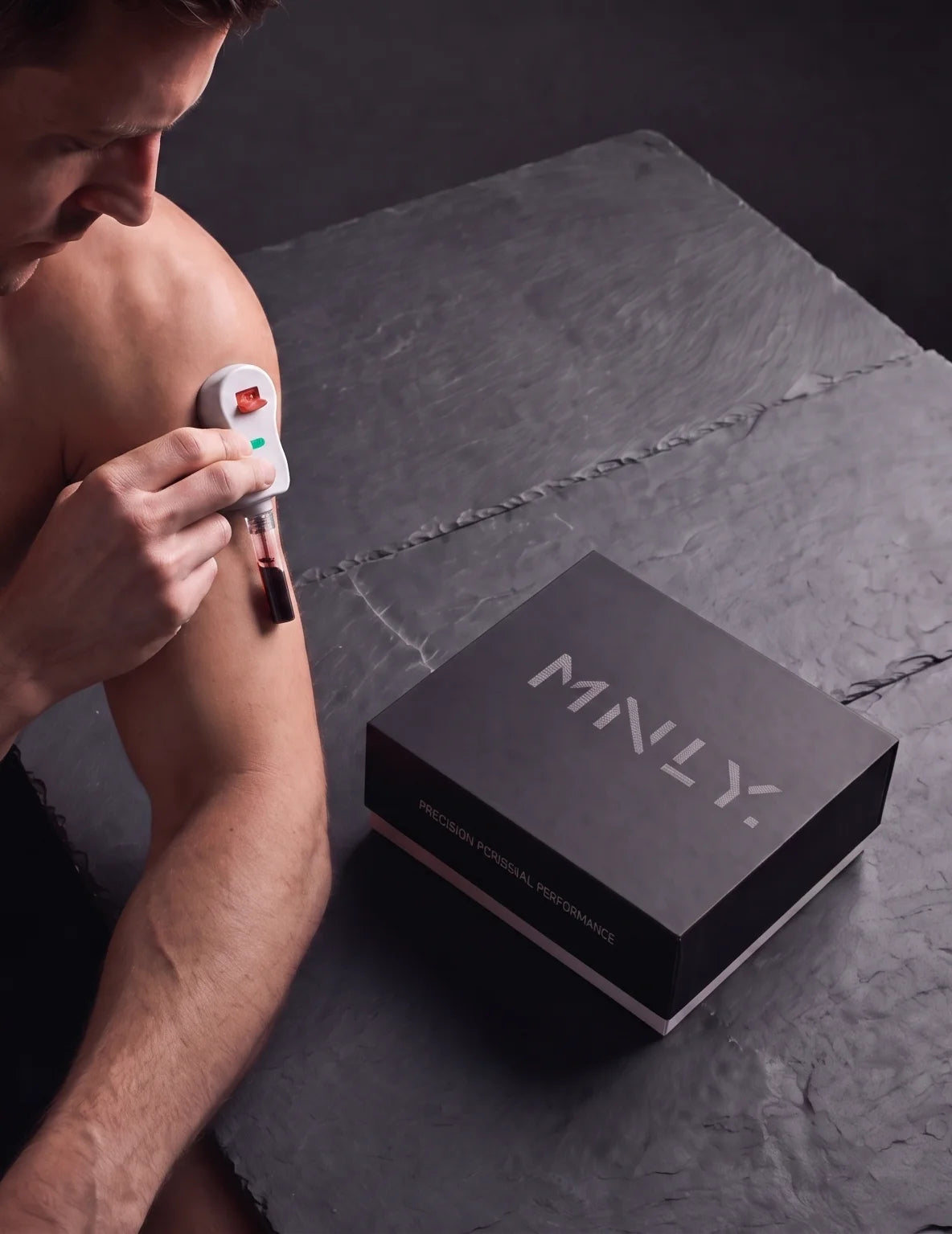 A man testing his blood at home beside the MNLY kit box