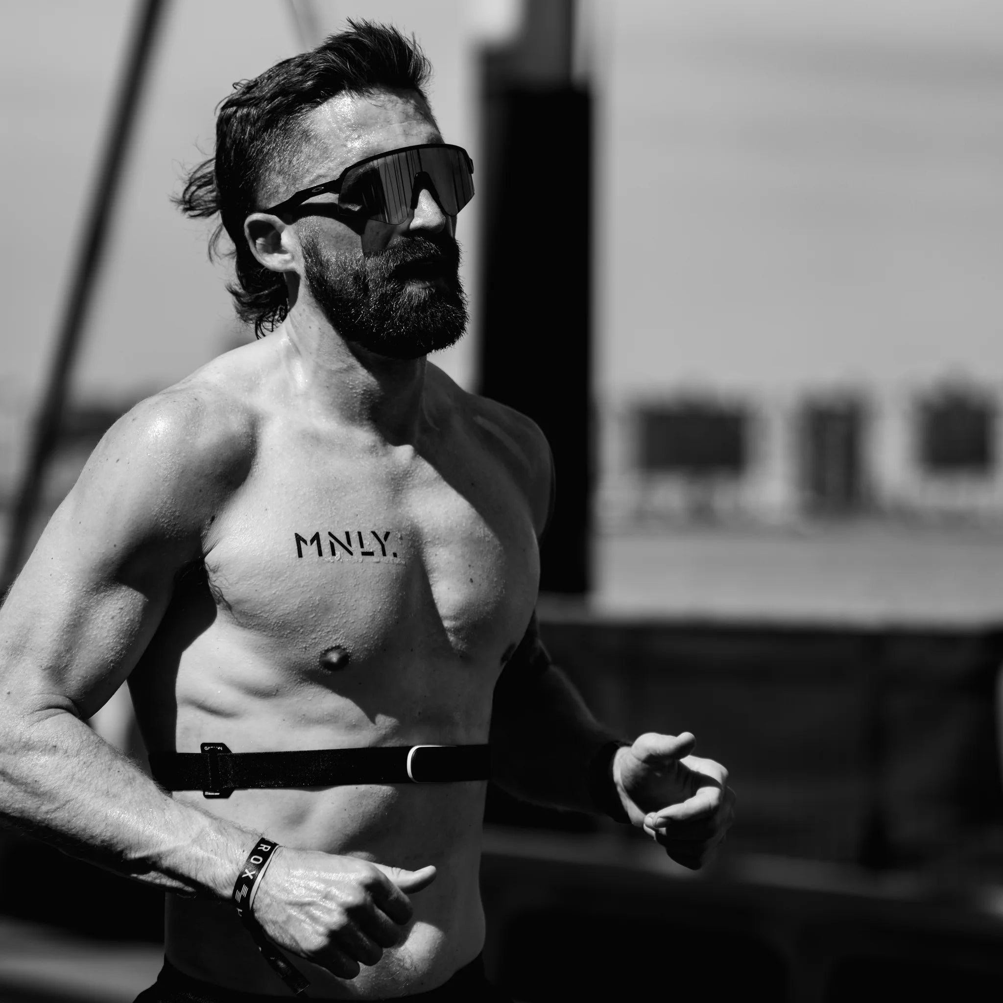 MNLY athlete mid race, chest marked with the MNLY wordmark