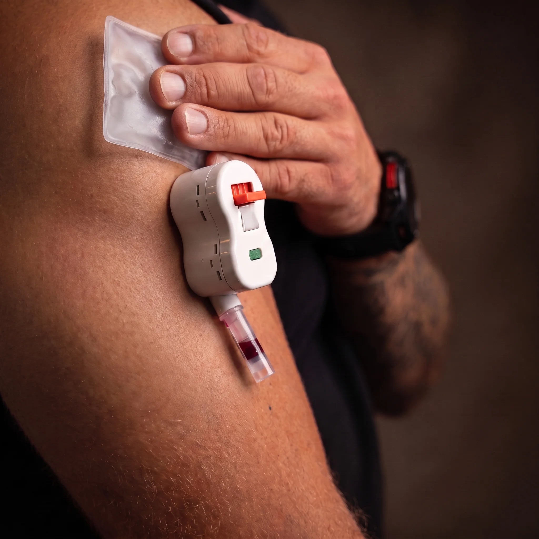 Close view of the MNLY blood-collection device filling its vial